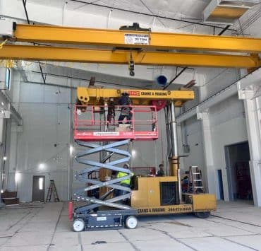 a 20-ton capacity overhead bridge crane being installed inside a industrial building