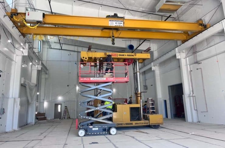 a 20-ton capacity overhead bridge crane being installed inside a industrial building